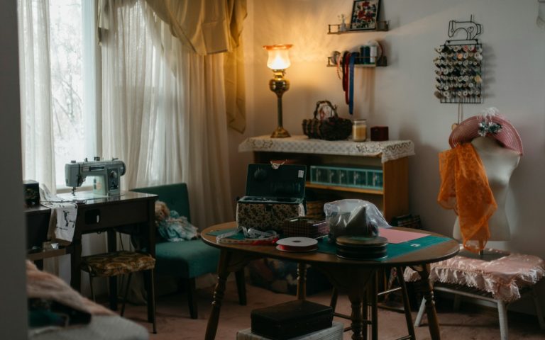 A sewing room with a vintage sewing machine and supplies.